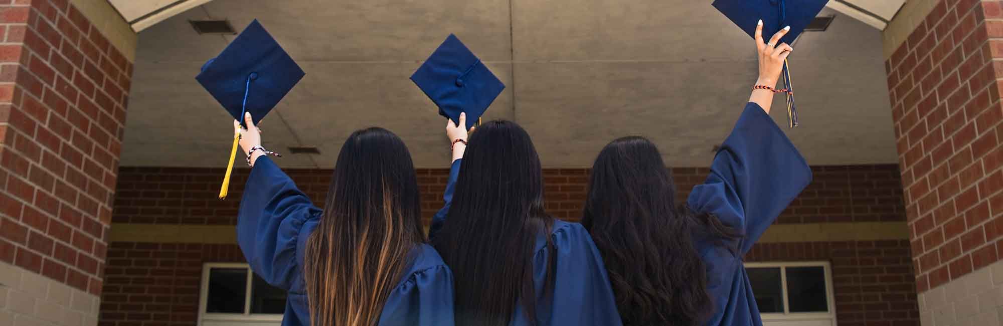 on the graduation day students stand in front of the university building